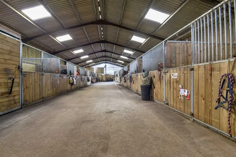 The bright central aisle of the American barn stables