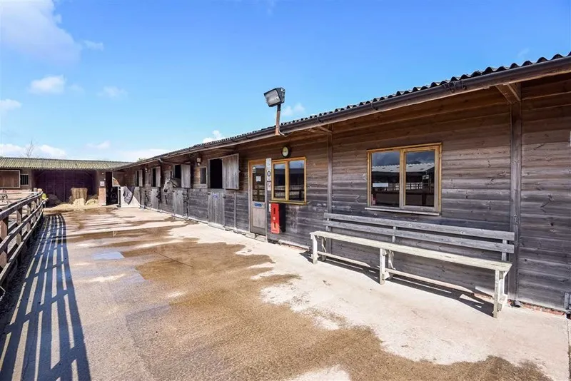 The timber stable block and rest room with a bench outside